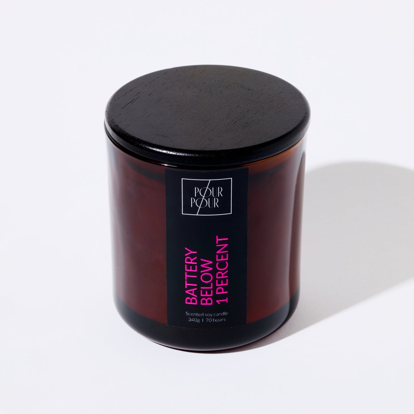 Candle jar with black lid and 'Pour Pour' branding on a white background