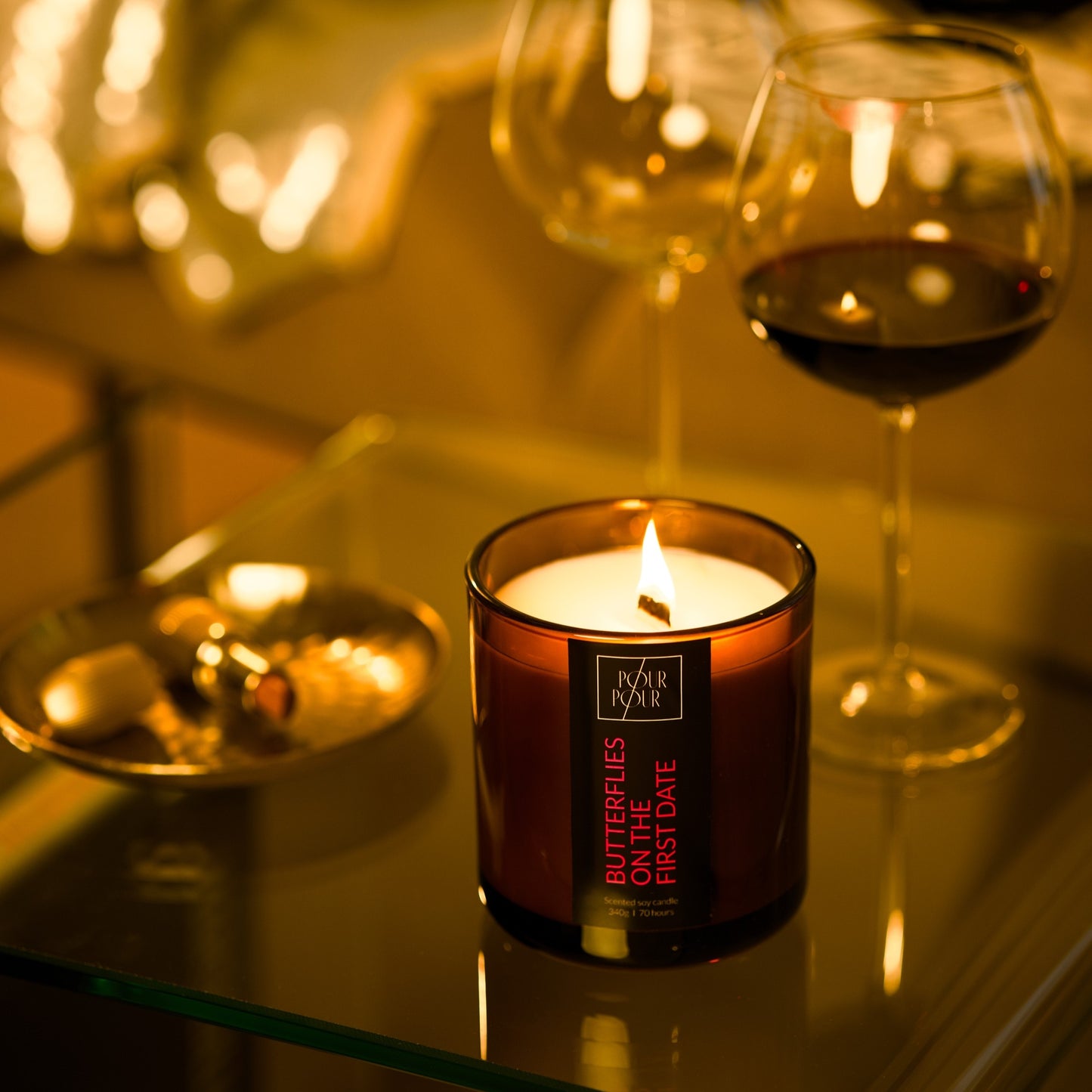 Candle with a wine glass and dish in a warm, cozy setting