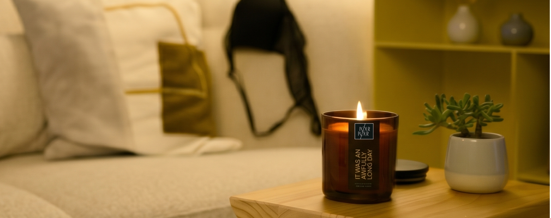 Cozy living room with a couch, candles, and decorative items.
