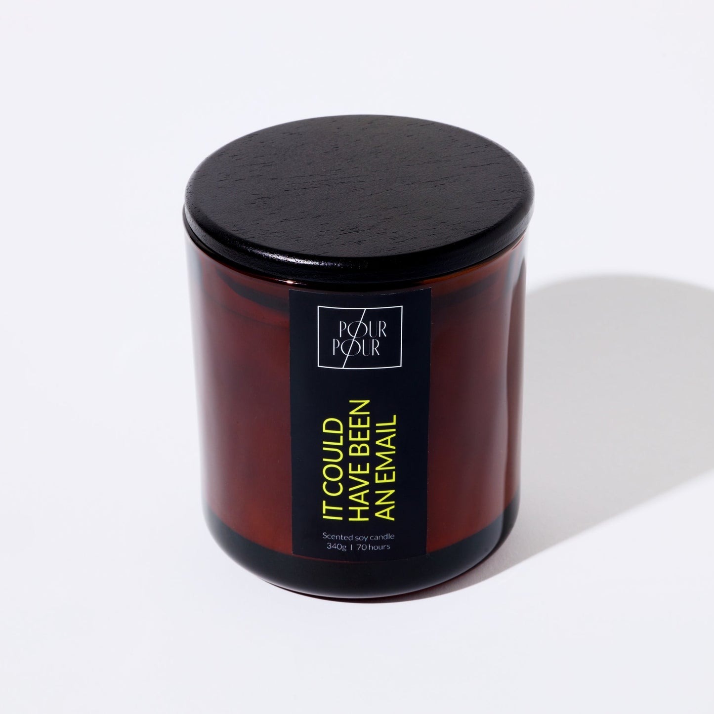 Candle jar with a black lid and visible branding on a white background