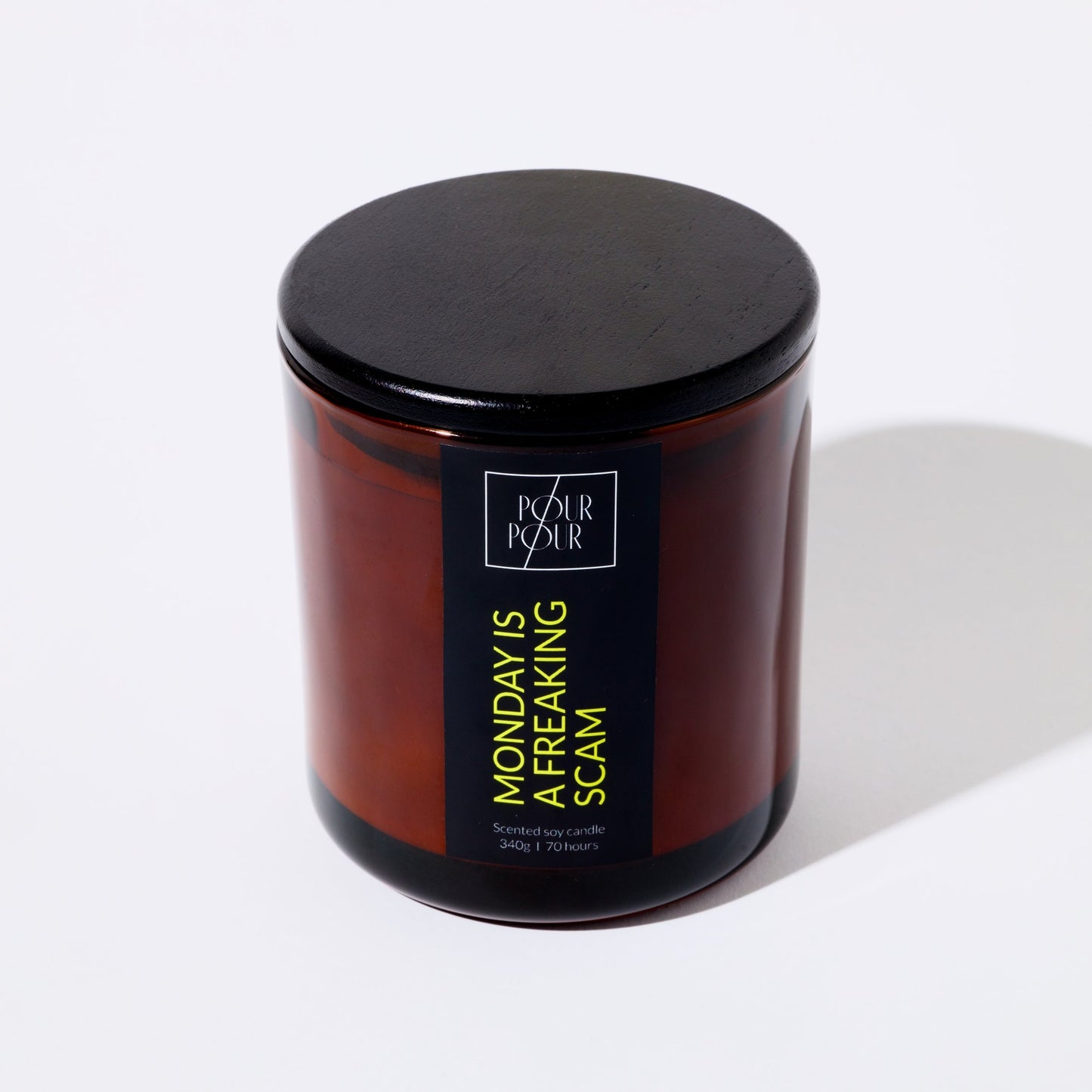 Candle jar with a black lid and label on a white background