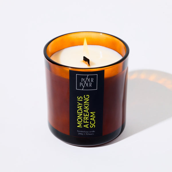 Candle in a brown glass jar with a label on a white background