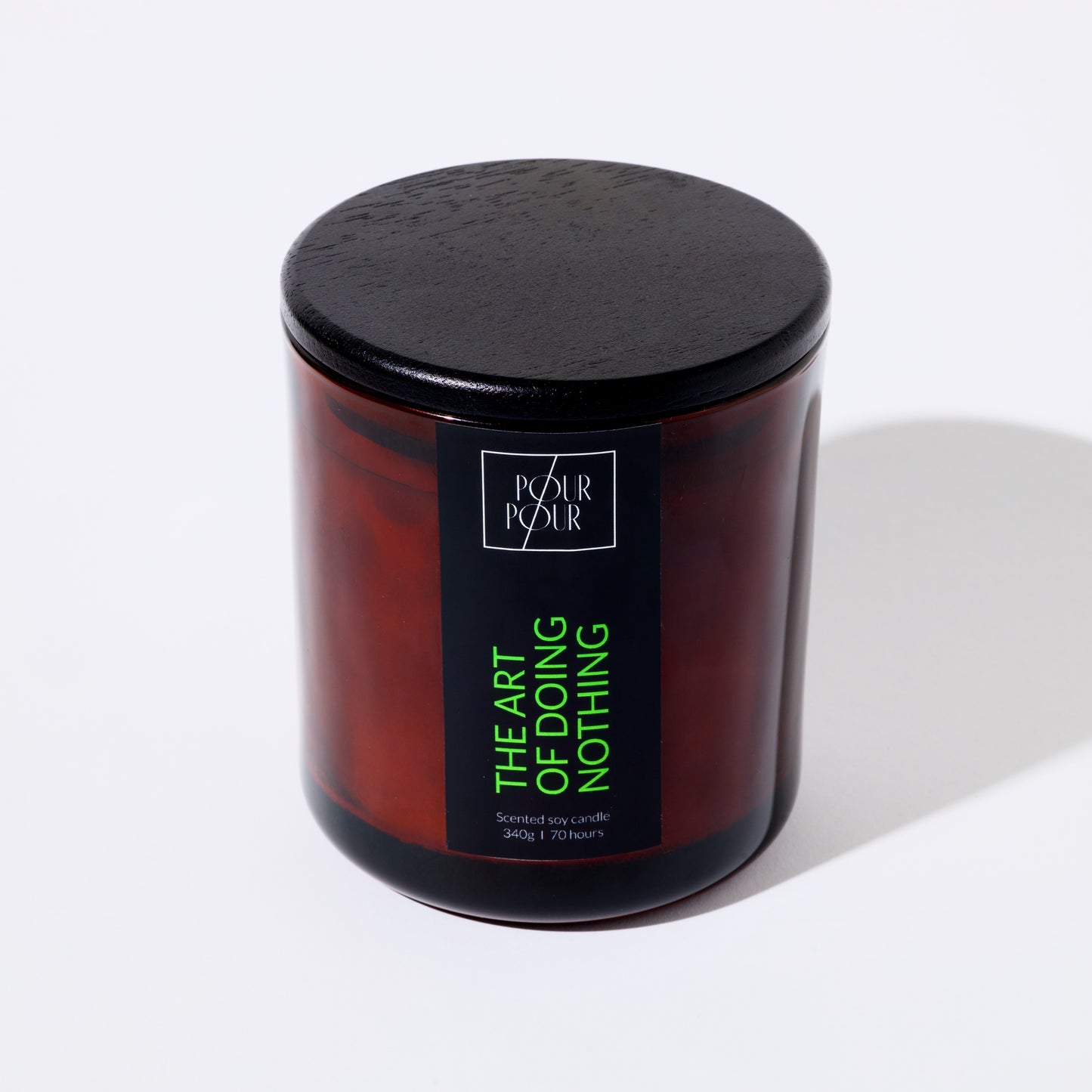 Candle jar with black lid and label on a white background