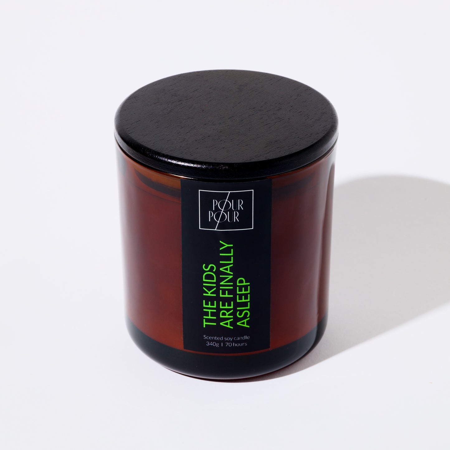 Candle jar with a black lid and label on a white background