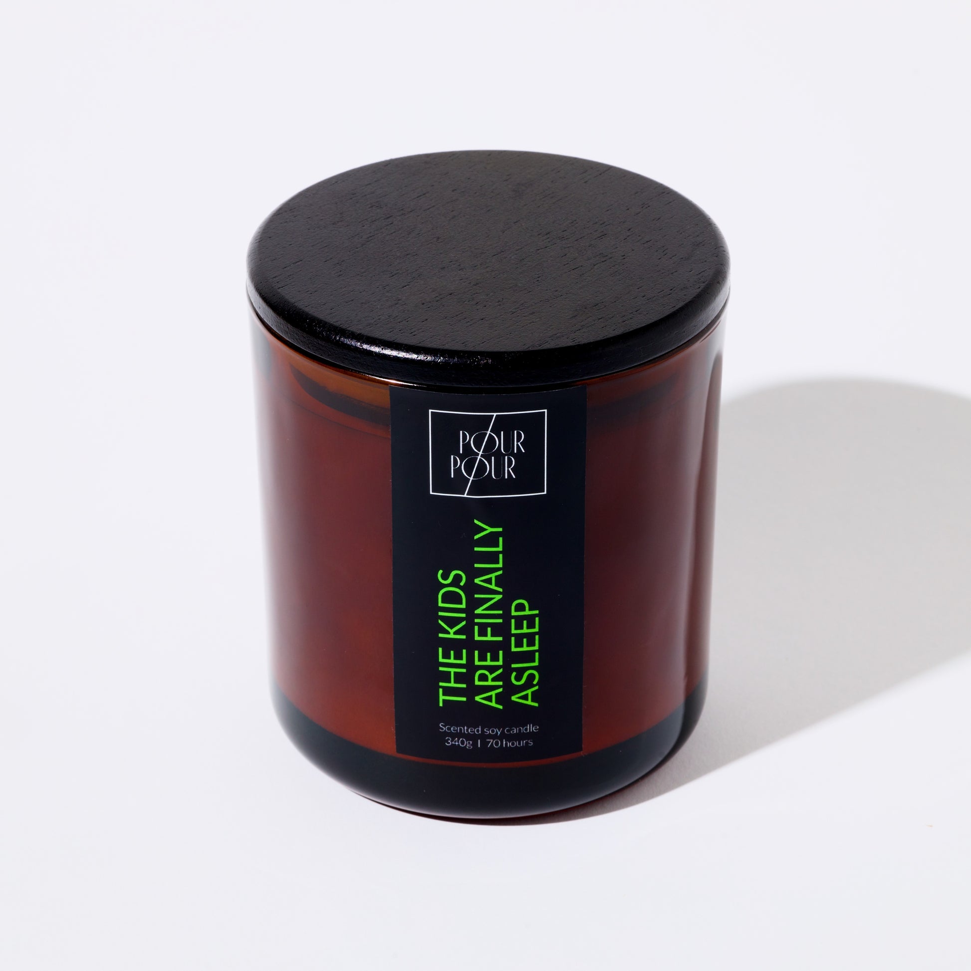 Candle jar with a black lid and label on a white background